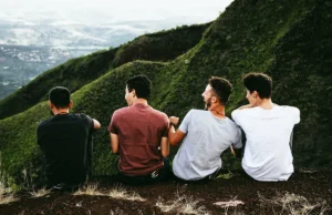 group of digital nomads sitting on a cliff